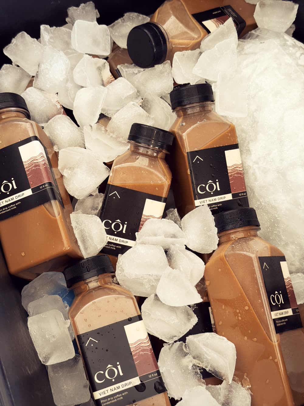 Cội 12 oz Viet Nam drip bottles packed in ice, ready to serve.